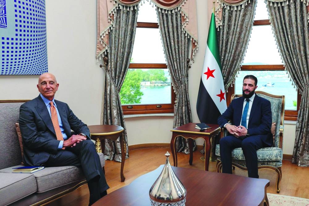 US Ambassador Thomas Barrack (L) during a meeting with Syria's President Ahmed al-Sharaa in Istanbul.