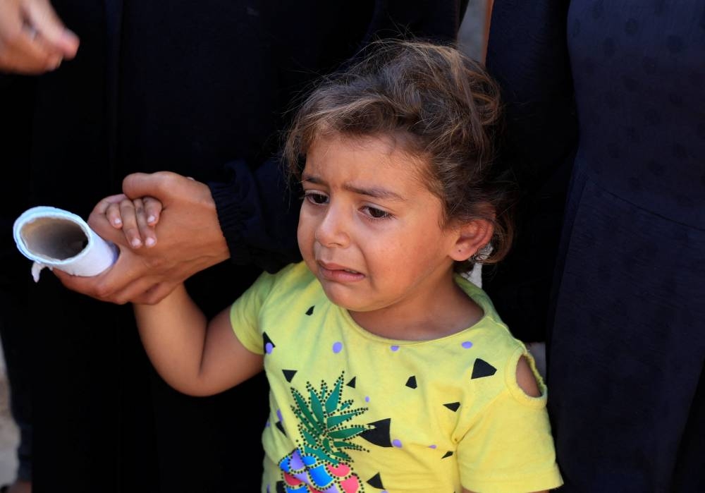 A girl reacts during the funeral of Palestinians killed in Israeli strikes, at Nasser hospital, in Khan Younis, southern Gaza Strip, on Sunday. REUTERS