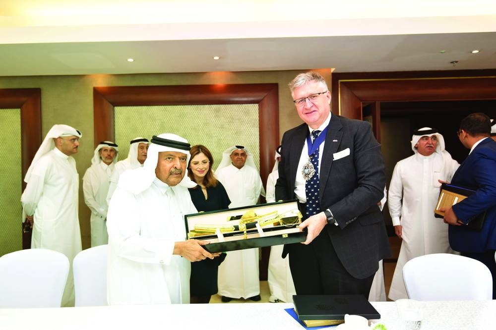 HE Sheikh Faisal presents a token of recognition to Lord Alastair King during a QBA-hosted luncheon held on the sidelines of his visit to Doha.