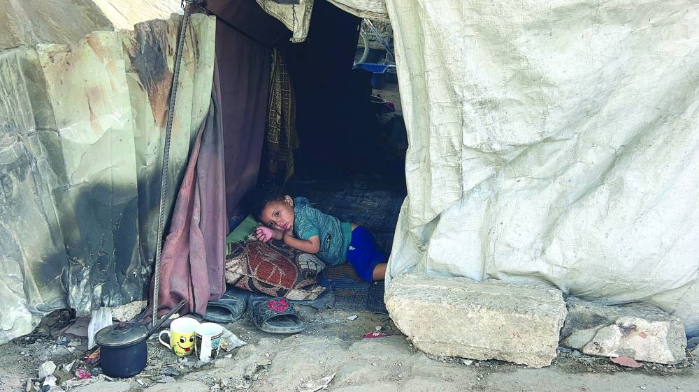 A Palestinian child lies inside a tent in Gaza City Monday.