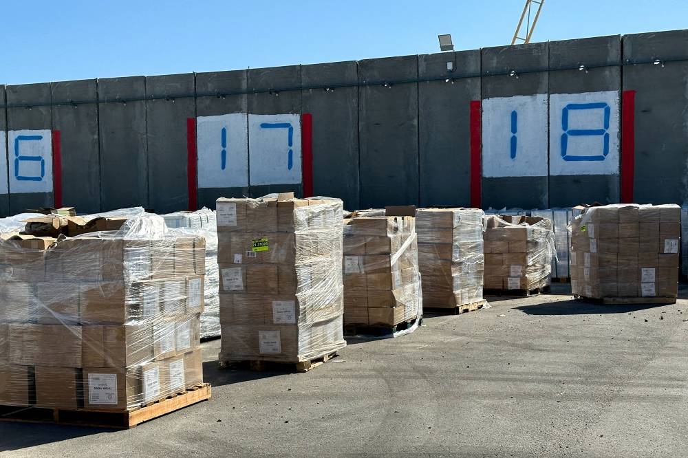 Supplies wait to be loaded on trucks to go into the Gaza Strip, at the Kerem Shalom crossing between Israel and Gaza, on its Israeli side, on Thursday. REUTERS