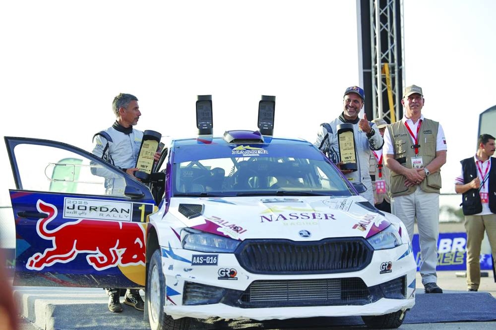 Qatar’s Nasser Saleh al-Attiyah and his Spanish co-driver Candido Carrera celebrate after winning the Jordan Rally yesterday.