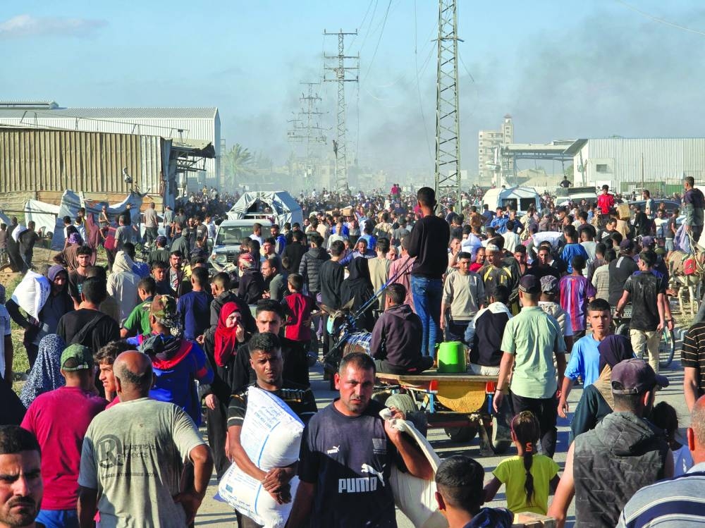 Palestinians gather at an aid distribution center in Deir Al-Balah