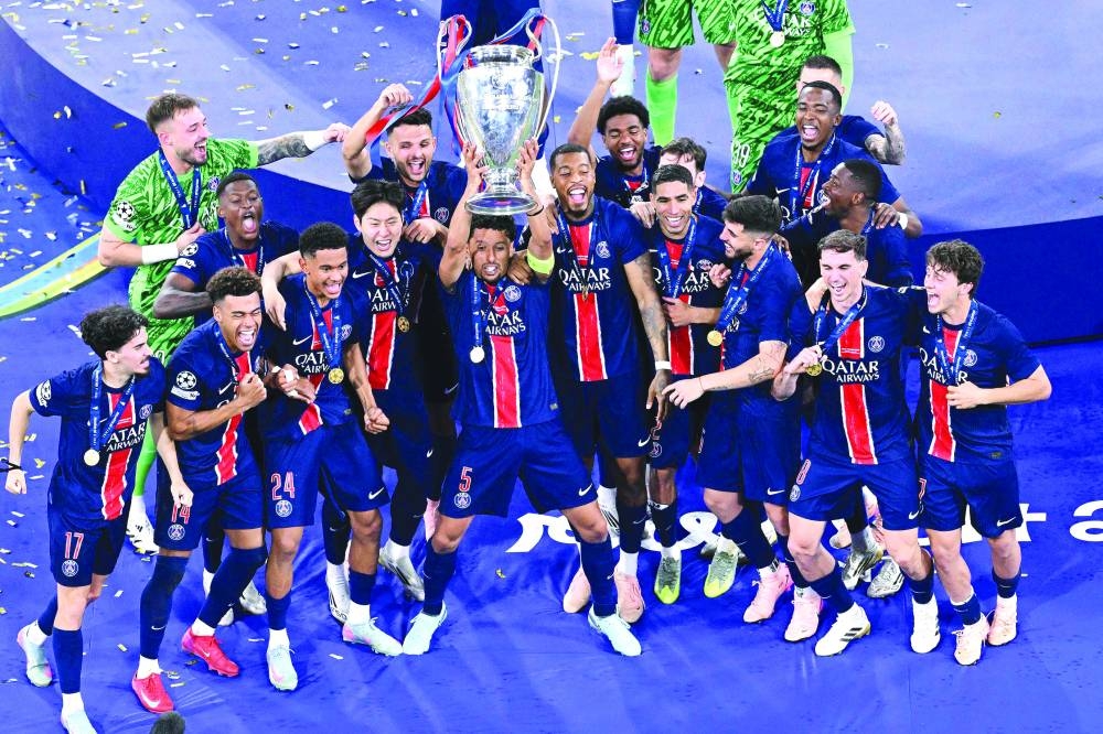 Paris Saint-Germain’s players celebrate with the trophy after winning the UEFA Champions League final against Inter Milan in Munich Saturday.