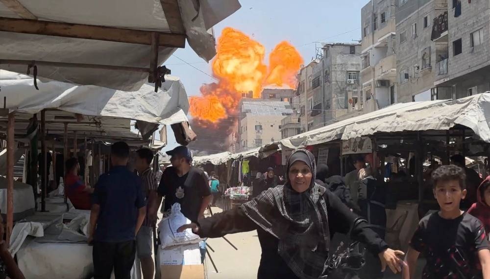 Smoke and flames rise from a house hit by an Israeli strike in Gaza City, on Sunday, in this screengrab taken from a video. Reuters TV/via REUTERS