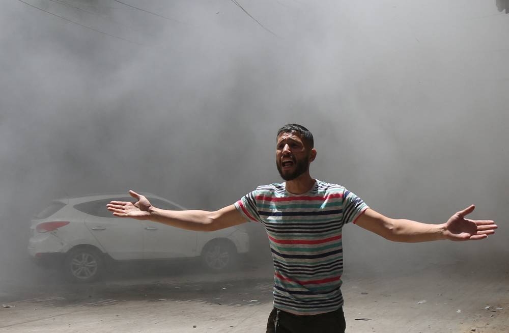 A Palestinian reacts at the site of an Israeli strike on a house, in Gaza City, on Sunday. REUTERS