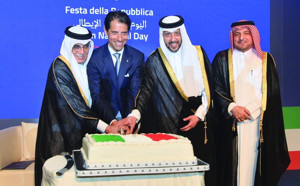 Italian ambassador Paolo Toschi, Qatar's Minister of Public Health HE Mansoor bin Ebrahim bin Saad al-Mahmoud and HE the Minister of State and president of Qatar National Library Dr Hamad bin Abdulaziz al-Kawari cut a ceremonial cake at the Italian National Day reception.  PICTURE: Shaji Kayamkulam