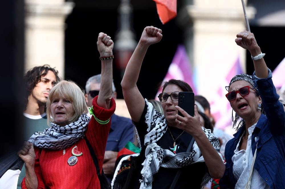 Participants gather during a rally to show their support for activists aboard a boat stopped by Israeli forces enroute to deliver aid to Gaza, during a rally in Lyon, south-eastern France on on Monday. AFP