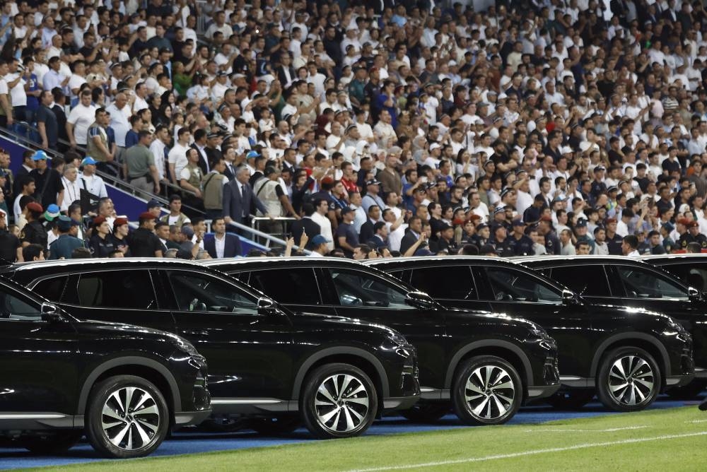Soccer Football - World Cup - AFC Qualifiers - Group A - Uzbekistan v Qatar - Milliy Stadium, Tashkent, Uzbekistan - June 10, 2025 General view of cars on the pitch after the match as Uzbekistan President Shavkat Mirziyoyev has decided to honor the national football team with a car for each player after securing a spot at the 2026 FIFA World Cup REUTERS/Maxim Shemetov