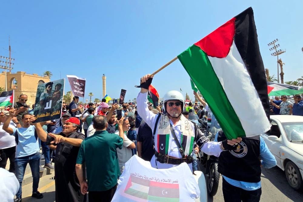 Activists, heading towards Gaza by land with the aim of breaking the siege on the Palestinian territory, are greeted by Libyans in Tripoli's Martyrs Square on Wednesday, one day after crossing into Libya from Tunisia. AFP
