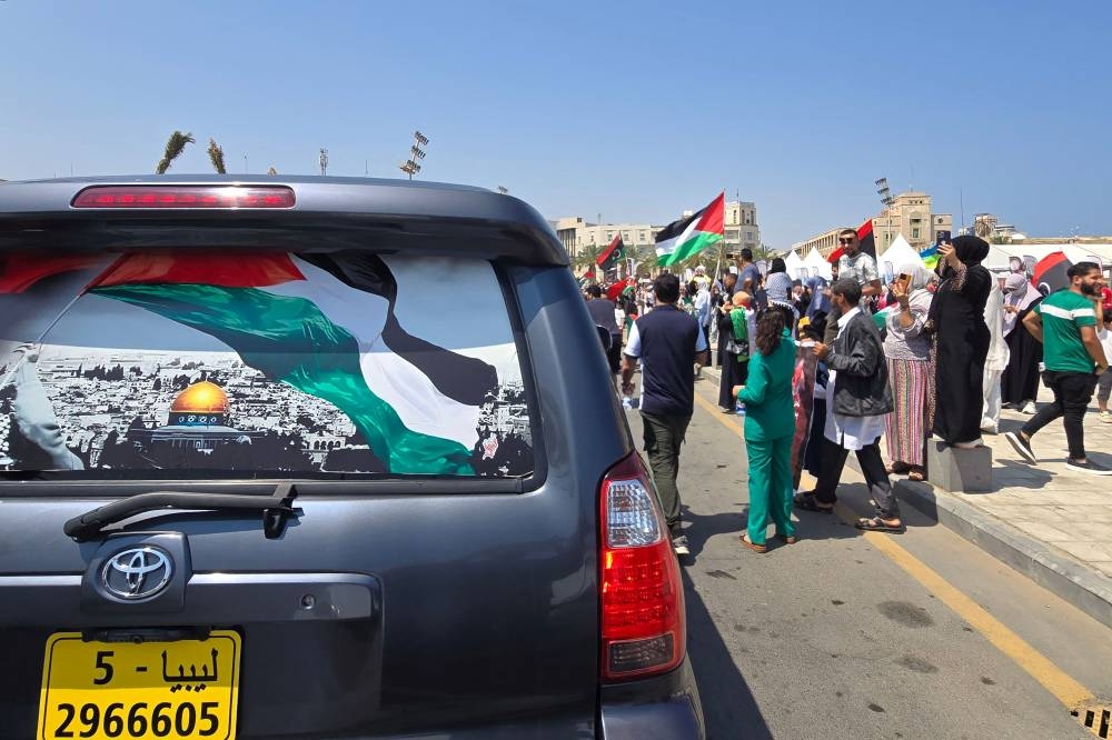 Libyans wave flags as they greet activists heading towards Gaza by land with the aim of breaking the siege on the Palestinian territory, in Tripoli's Martyrs Square on Wednesday, one day after crossing into Libya from Tunisia. AFP