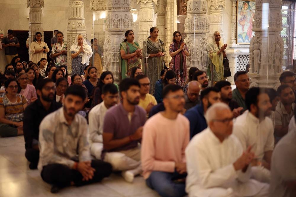 Worshippers attend a memorial service at Neasden Temple in northwest London on Friday, a day after a London-bound Air India ploughed into a residential area of India's Ahmedabad city. AFP