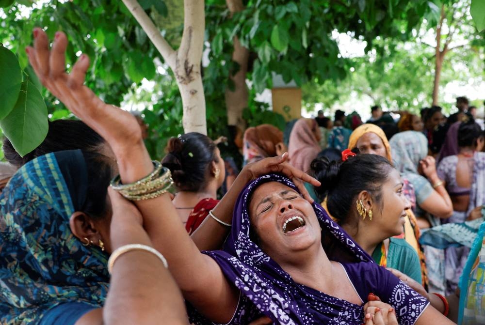 Daksha Patni mourns for her relative Akash Patni, 14, who died when an Air India Boeing 787-8 Dreamliner aircraft crashed during take-off from an airport, as she waits outside the post-mortem room at a hospital, in Ahmedabad, India, on Friday. REUTERS