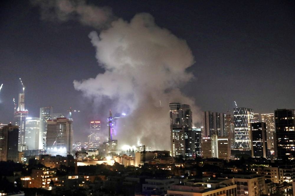 Smoke billows following missile attack from Iran on Israel, at Tel Aviv, Israel on Friday. REUTERS
