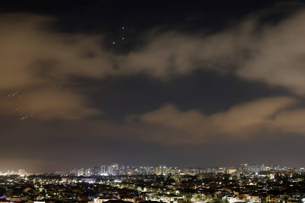 Missiles launched from Iran towards Israel are intercepted, as seen from Ashkelon, Israeli, on Saturday. REUTERS