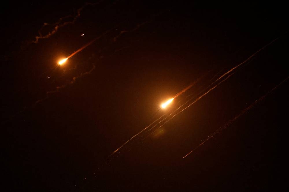 Missiles launched from Iran towards Israel are seen from Tubas, in the Israeli-occupied West Bank, on Saturday. REUTERS