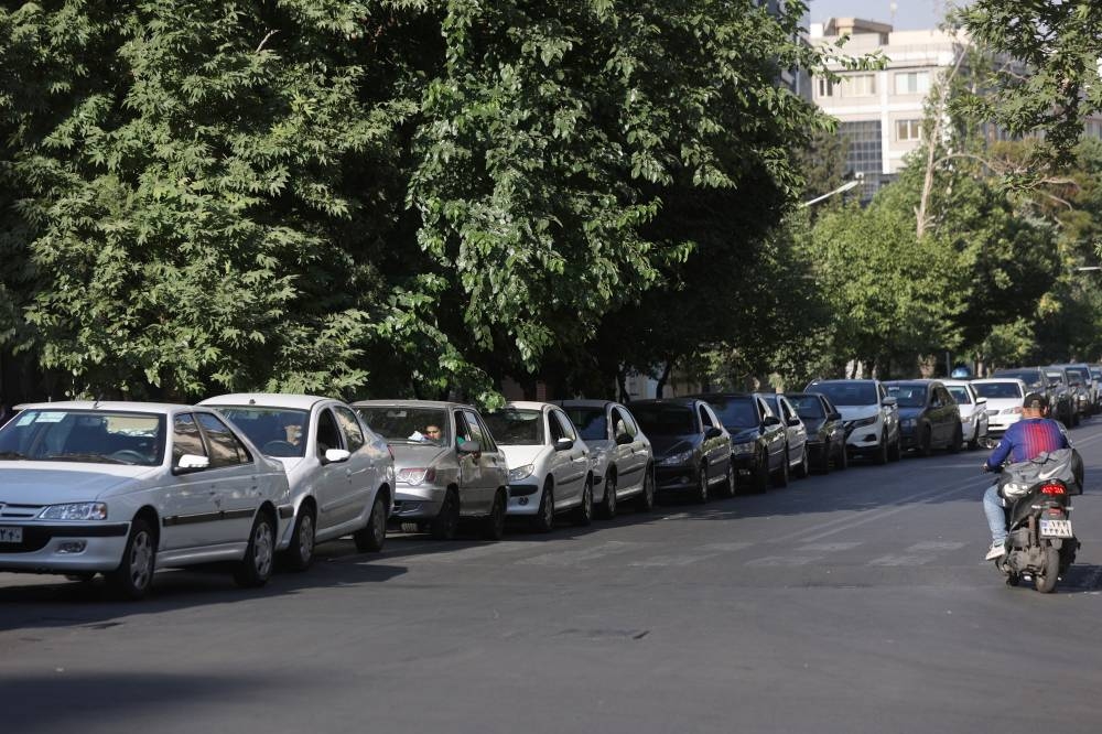 Cars are lined up near a gas station following the Israeli strikes on Iran, in Tehran, Iran, on Sunday. WANA via REUTERS