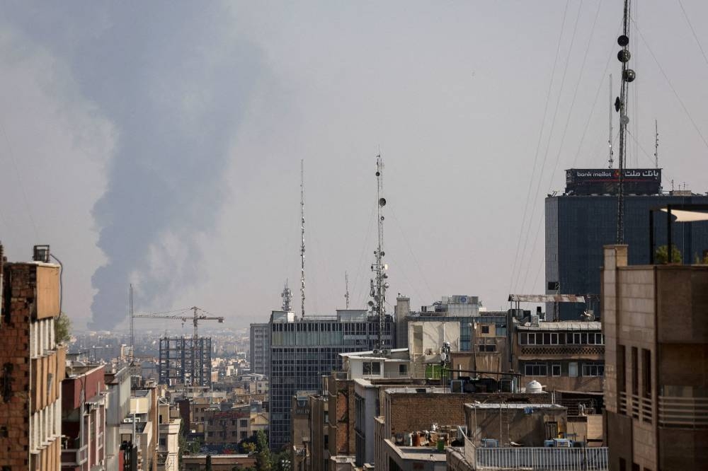 Smoke rises following an Israeli attack on Tehran Oil Refinery, in south of Tehran, Iran, on Sunday. WANA via REUTERS