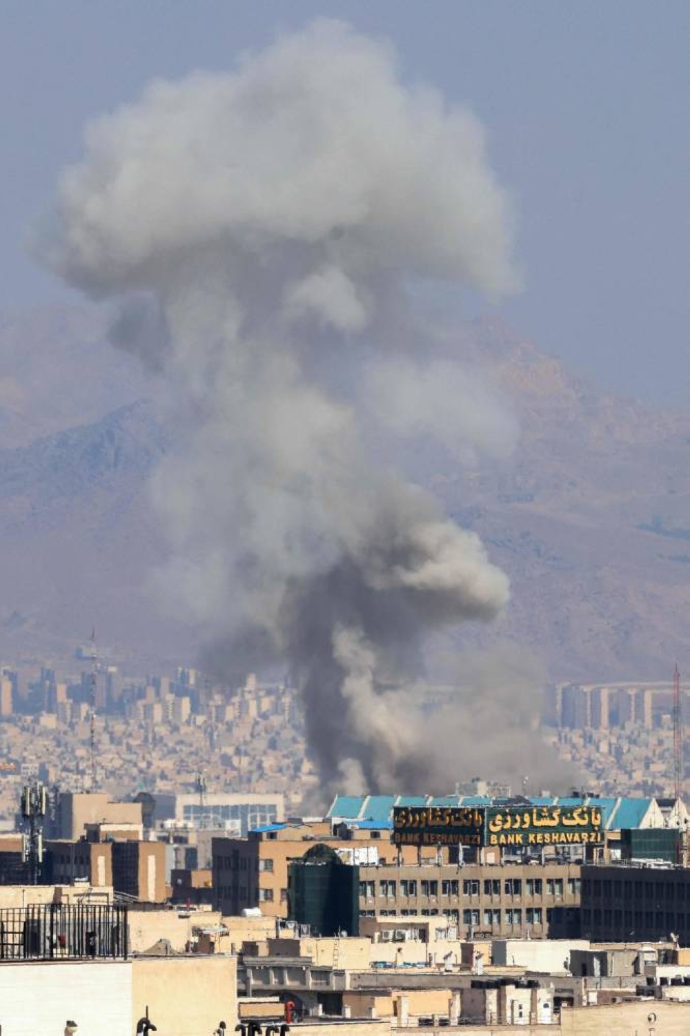 Smoke billows following an explosion in central Tehran Sunday.