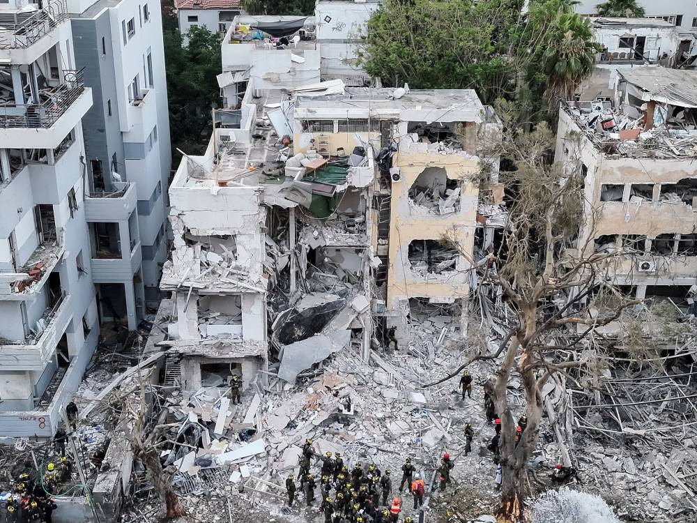 A drone photo shows the damage over residential homes at the impact site following missile attack from Iran on Israel, in Tel Aviv, Israel, on Monday. REUTERS
