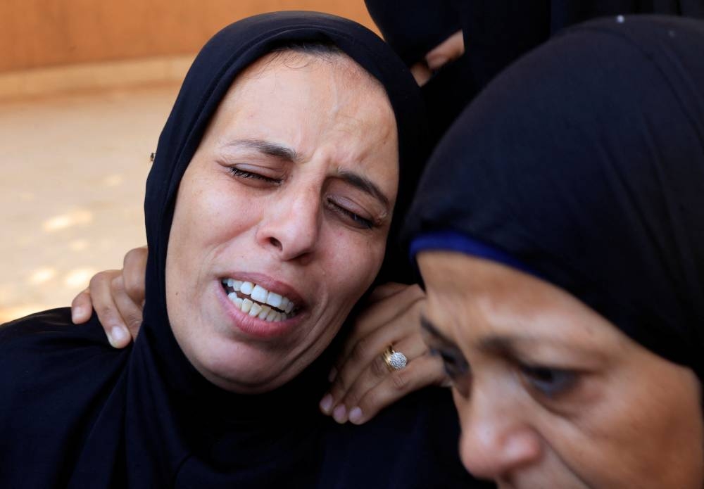Mourners react during the funeral of Palestinians killed in Israeli strikes, in Khan Younis, southern Gaza Strip, on Tuesday. REUTERS