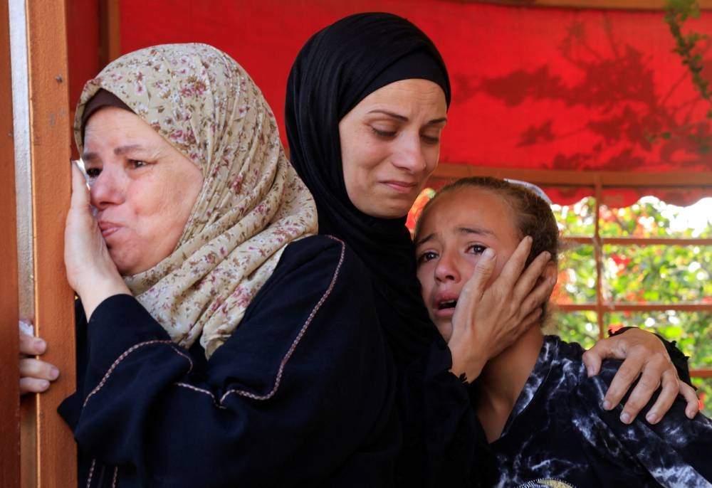 Mourners react during the funeral of Palestinians killed in Israeli strikes, in Khan Younis, southern Gaza Strip, on Tuesday. REUTERS