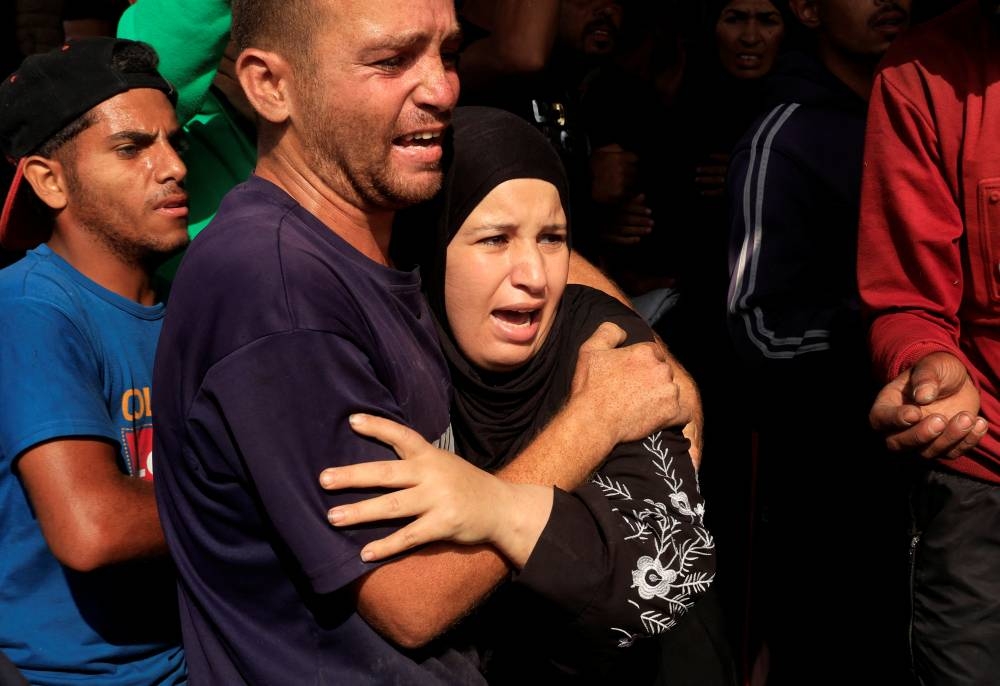 People react as Palestinian casualties, who were waiting to receive aid, are brought into Nasser hospital following an Israeli strike, in Khan Younis, southern Gaza Strip, on Tuesday. REUTERS