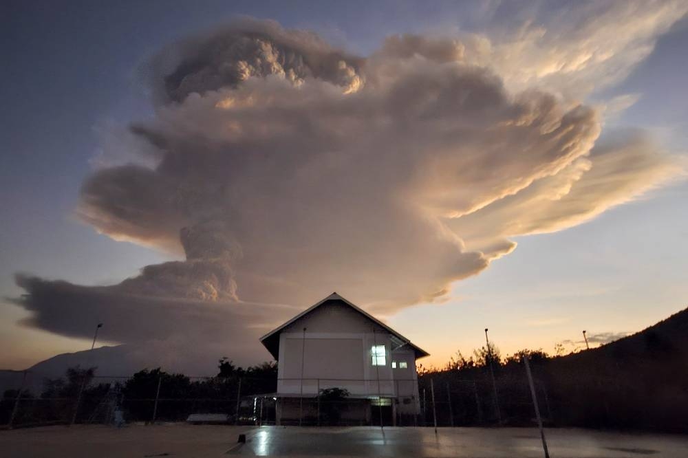 Mount Lewotobi Laki-laki spews smoke and volcanic ash as seen from Kawalelo village in East Nusa Tenggara province, Indonesia, on Tuesday. REUTERS