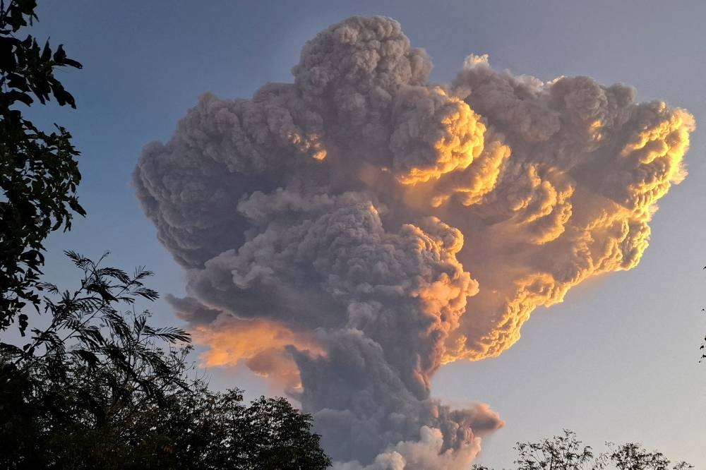 Mount Lewotobi Laki-laki spews smoke and volcanic ash as seen from Kawalelo village in East Nusa Tenggara province, Indonesia, on Tuesday. REUTERS