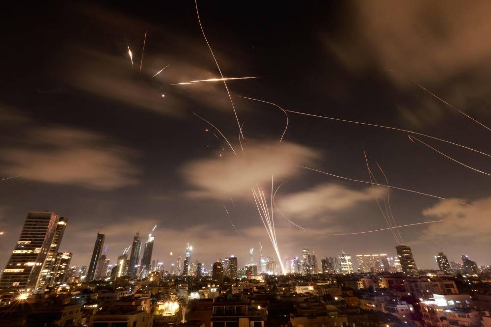 Israeli air defence systems are activated to intercept Iranian missiles over the Israeli city of Tel Aviv early on Wednesday. AFP