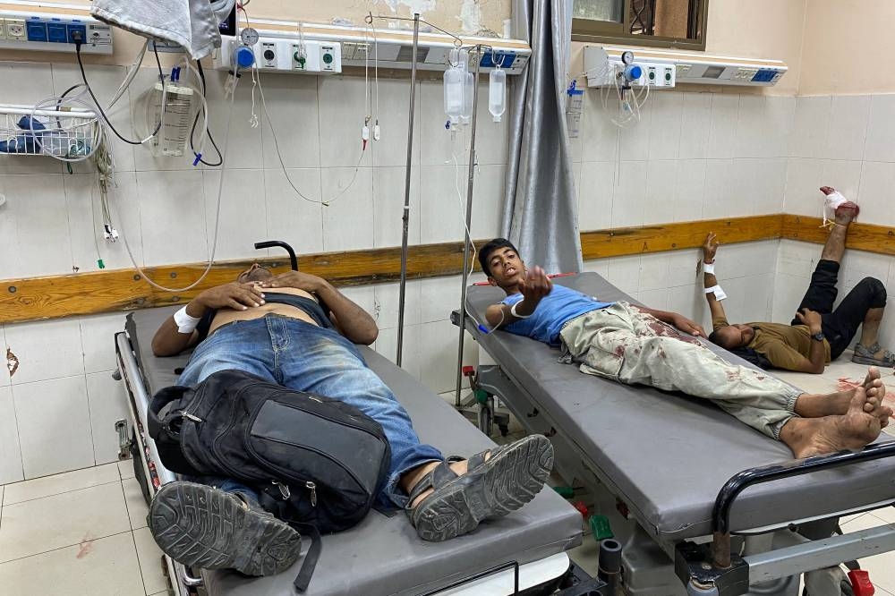 Palestinian men await medical attention at Khan Yunis' Nasser hospital in the southern Gaza Strip on Thursday. AFP