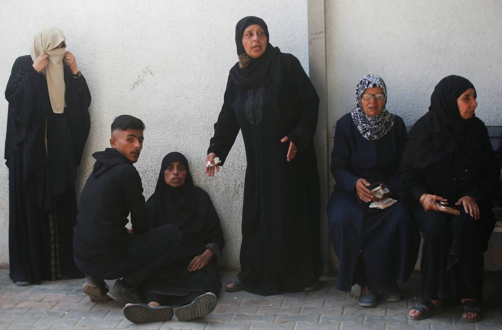 Mourners react during the funeral of Palestinians, who, according to Gaza’s health ministry, were killed in an Israeli airstrike on a house on Friday, at Al-Shifa Hospital, in Gaza City, on Saturday. REUTERS