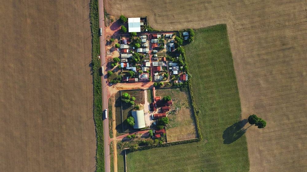 
A drone view shows the Vitalina Motta school, surrounding soy fields and trucks loaded with soybean passing along the road, where the farming expanded in the Amazon, in Belterra, Para state. (Reuters) 
