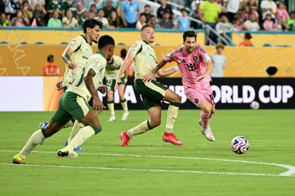 Inter Miami's Argentine forward #10 Lionel Messi (R) fights for the ball qith Palmeiras' Brazilian defender #03 Bruno Fuchs (2nd R) during the FIFA Club World Cup 2025 Group A football match between US Inter Miami and Brazil's Palmeiras at the Hard Rock stadium in Miami on June 23, 2025. (Photo by PATRICIA DE MELO MOREIRA / AFP)