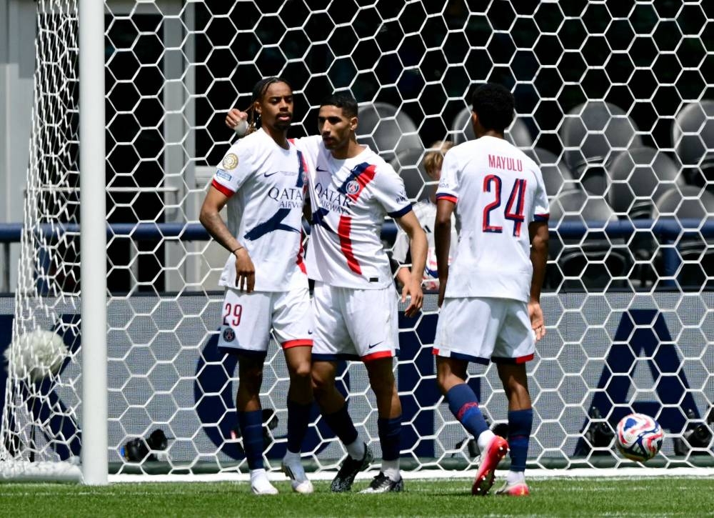 Paris Saint-Germain's Moroccan defender #02 Achraf Hakimi (C) celebrates scoring his team's second goal with Paris Saint-Germain's French forward #29 Bradley Barcola during the FIFA Club World Cup 2025 Group B football match between US Seattle Sounders and France's Paris Saint-Germain at the Lumen Field stadium in Seattle on June 23, 2025. (Photo by Pablo PORCIUNCULA / AFP)