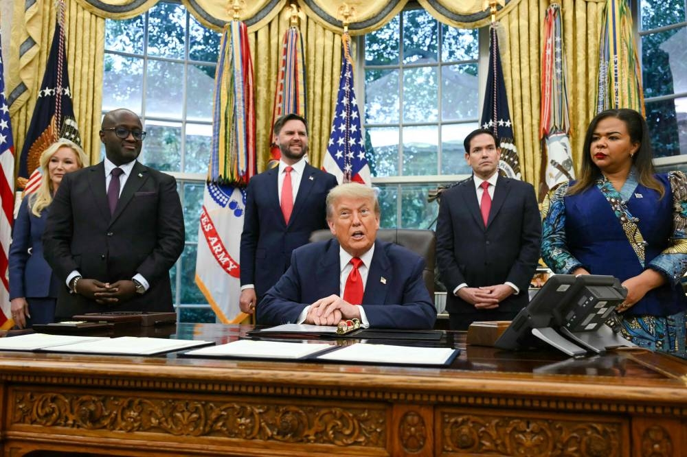 US President Donald Trump speaks during a meeting with Democratic Republic of the Congo Foreign Minister Thérèse Kayikwamba Wagner (R) and Rwandan Foreign Minister Olivier Nduhungirehe (2nd-L) in the Oval Office of the White House in Washington, DC, on Friday. AFP