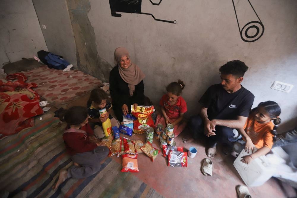Iman Suleiman, a displaced Palestinian woman from Beit Lahiya, sits inside the ruins of a damaged house where she is sheltering with her family, in Gaza City, on Monday. REUTERS