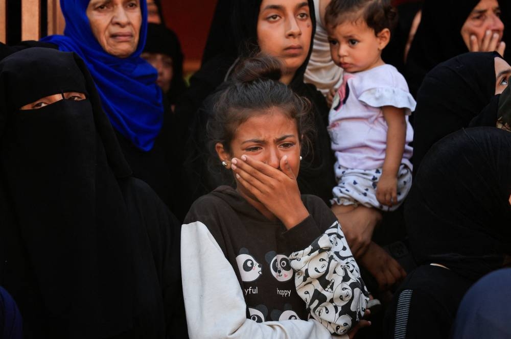 Mourners react during the funeral of Palestinians, who, according to Gaza's health ministry, were killed in an overnight Israeli strike on a tent, at Nasser Hospital in Khan Younis, southern Gaza Strip, on Wednesday. REUTERS