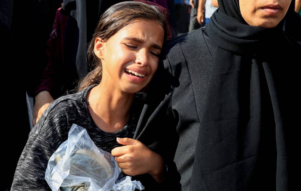 A mourner reacts as she attends the funeral of Palestinians killed overnight in Israeli attacks on a tent and on people seeking aid, according to Gaza's health ministry, at Nasser Hospital in Khan Younis, southern Gaza Strip, on Friday. REUTERS