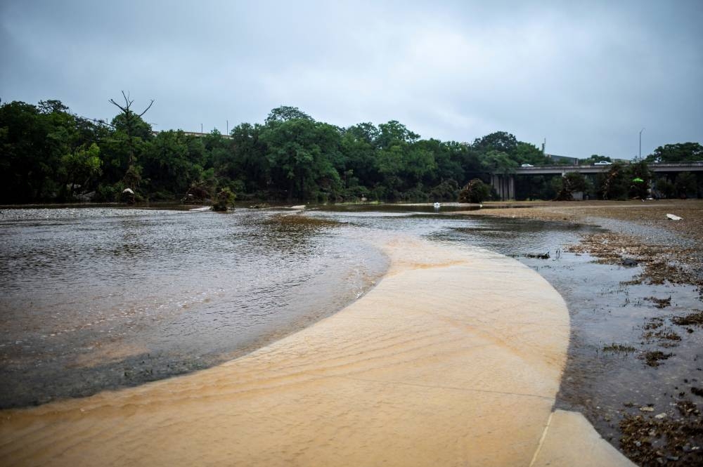 Floodwaters cover a walkway at Louise Hays Park after deadly flooding in Kerrville, Texas, on Friday,