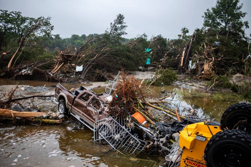 A pickup truck sits damaged after deadly flooding in Kerrville, Texas, on Friday,