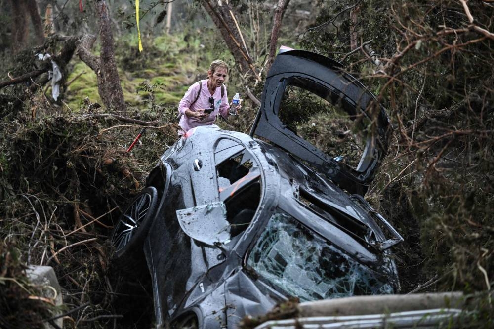 A volunteer looks for missing people, following severe flash flooding that occurred during the July 4 holiday weekend, in Hunt, Texas, on Sunday. AFP