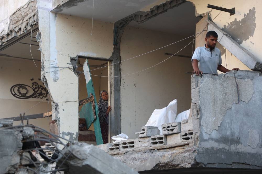 Palestinians inspect the damage at the site of an Israeli strike on the Al-Shati refugee camp, west of Gaza City, on Wednesday. AFP