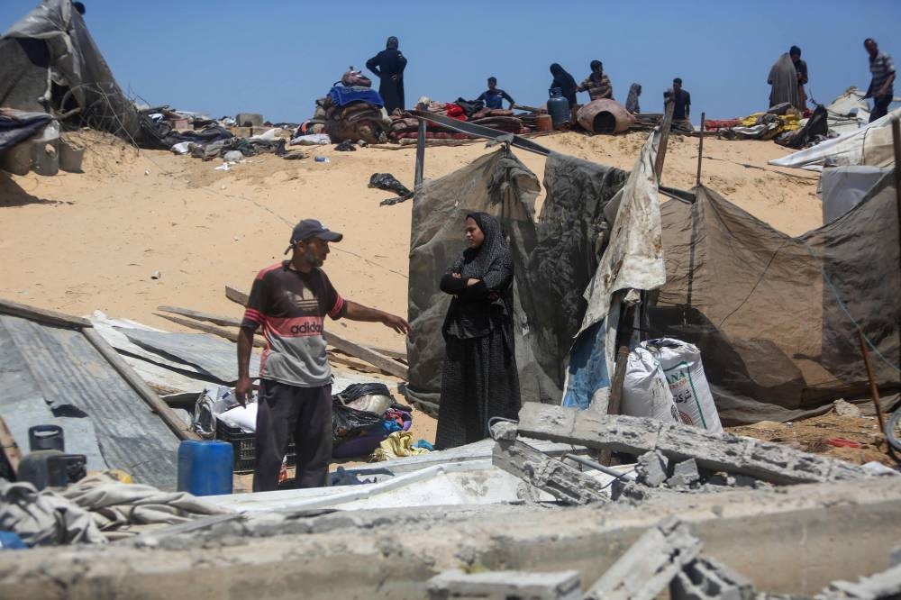 Palestinians inspect the destruction at a makeshift displacement camp following a reported incursion a day earlier by Israeli tanks in the area in Khan Yunis in the southern Gaza strip, on Friday. AFP