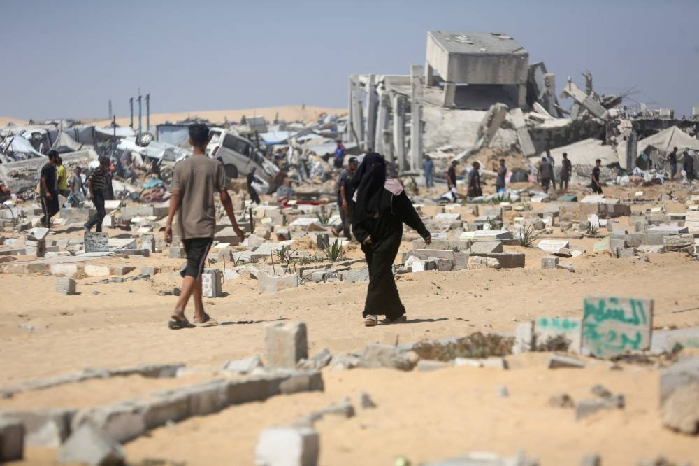 Palestinians inspect the destruction at a makeshift displacement camp and adjacent cemetery following a reported incursion a day earlier by Israeli tanks in the area in Khan Yunis in the southern Gaza strip, on Friday. AFP