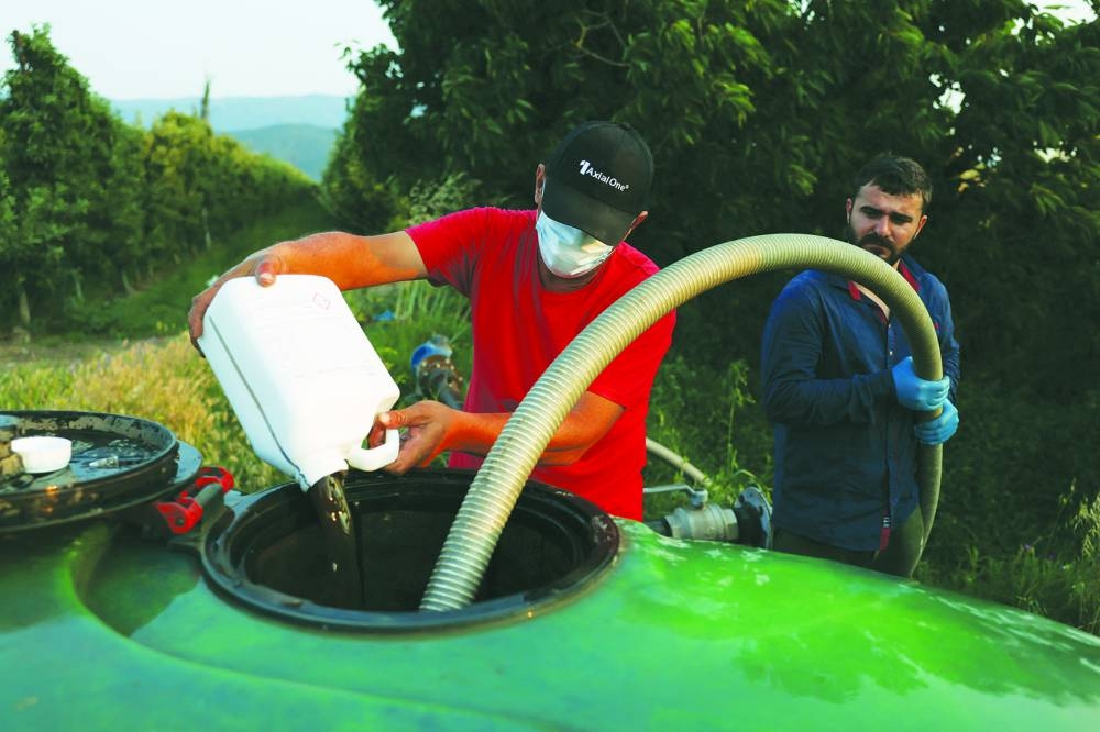 
Alberto, a local farmer, pours pesticides into an agricultural spraying machine, in the village of Agia in Thessaly region, Greece. 