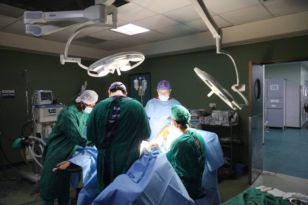 Surgeons operate on an injured Palestinian at the Nasser hospital in Khan Yunis in the southern Gaza Strip on Friday. AFP