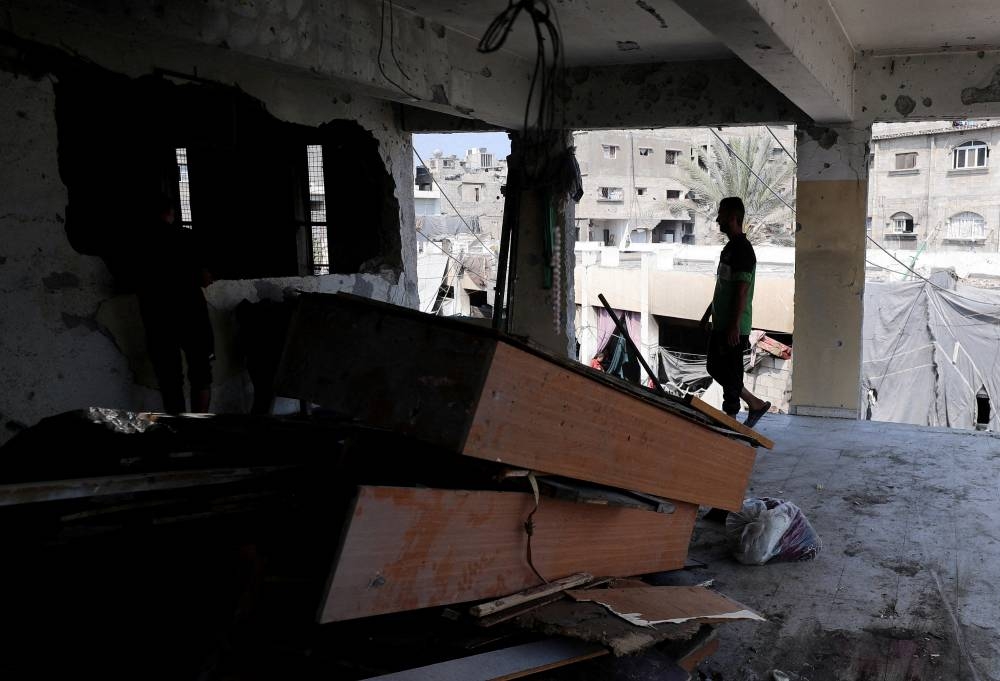 Palestinians inspect the damage following an overnight Israeli strike on a school sheltering displaced families, in Jabalia, in the northern Gaza Strip, Friday. REUTERS