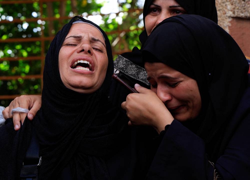 Mourners react during the funeral of Palestinians killed in morning Israeli strikes on tents sheltering displaced people, at Nasser Hospital in Khan Younis, southern Gaza Strip, on Monday. REUTERS