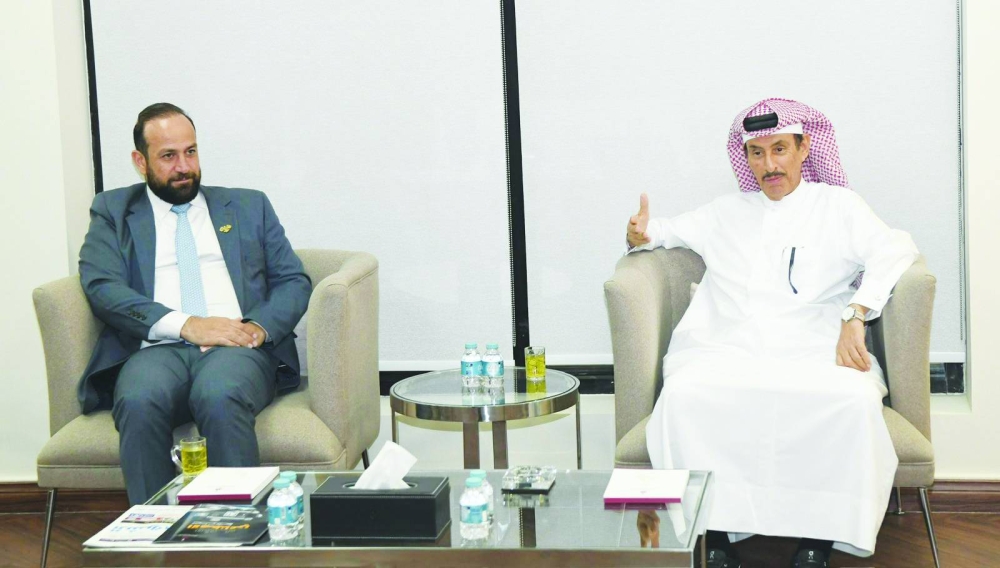 Syrian Minister of Information Hamza al-Mustafa with Saad bin Mohammed al-Rumaihi, chairman of the Qatar Press Center.